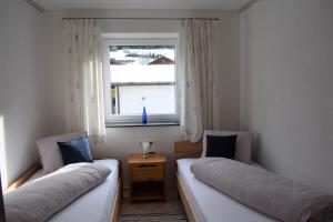 two beds in a room with a window at Apartment Nagiller in Rinn