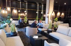 a group of people sitting in a lobby at Le Grand Hôtel Le Touquet-Paris-Plage in Le Touquet-Paris-Plage