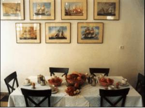 a dining room table with a white table cloth and chairs at Ilis Hotel in Olympia
