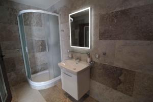 a bathroom with a sink and a shower at Residence Safari Resort - Bison Lodge in Borovany