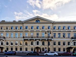a large building with cars parked in front of it at Petr Hotel in Saint Petersburg