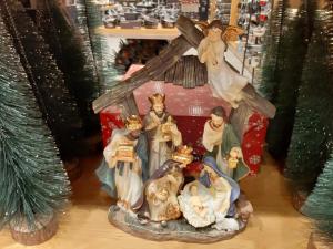 a group of christmas figurines in front of a cross at Royal Guest House in Nazareth