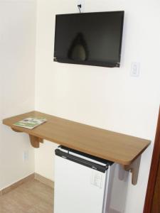 a wooden counter with a tv on a wall at Parque Hotel de Lambari in Lambari