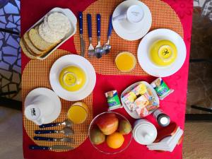 a table with breakfast foods and drinks on it at San Pedro Domos in San Pedro de Atacama