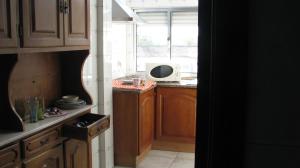 a kitchen with a microwave sitting on top of a counter at Residencial Porto Novo - Alojamento Local in Porto