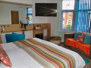 a bedroom with a bed and a kitchen with a counter at The Beaucliffe in Blackpool