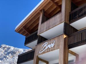 a building with a sign on the side of it at Hotel Garni Broi - Charme & Relax in Selva di Val Gardena