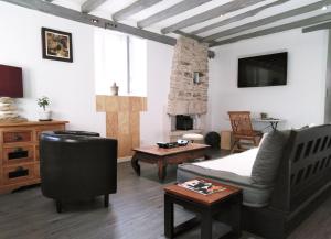 a living room with a bed and a couch and a table at Wood Stone and Wine in Beaune