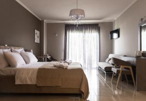 a bedroom with a bed and a living room at Phaedra Suites in Lixouri