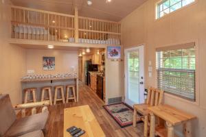 a kitchen and living room with a table and chairs at Sun Outdoors Lake Rudolph in Santa Claus