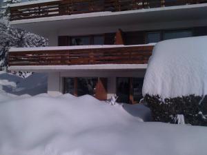 une maison recouverte de neige avec un tas de neige dans l'établissement Grain d'Or - Studio 007, à Verbier