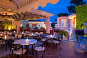 a patio with tables and chairs and lights at Hotel Continental Ischia in Ischia