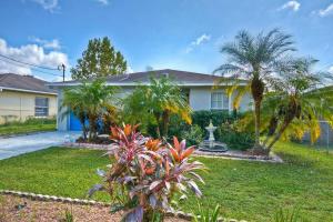a house with palm trees in a yard at Ybor Casita! Steps away from Centro Ybor! in Tampa