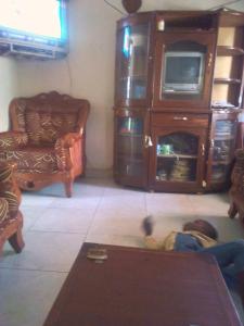 a boy laying on the floor in a living room at MOCAP in Kampala