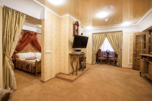 a living room filled with furniture and a tv at Bukovyna Hotel in Chernivtsi