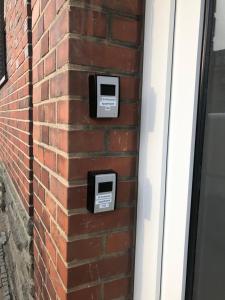 a brick wall with two mail boxes on it at Studio Apartment in Alsdorf
