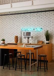 a kitchen with a wooden counter and stools at Bluebird Spa City Motor Lodge in Saratoga Springs