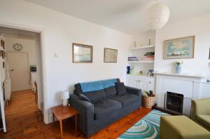 a living room with a couch and a table at Admirals Cottage in Yarmouth