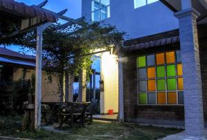 a house with colorful stained glass windows on it at Andalus beach residence in Marang