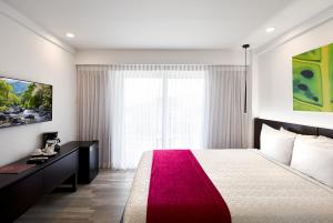 a bedroom with a large bed and a large window at R Hotel Kingston in Kingston