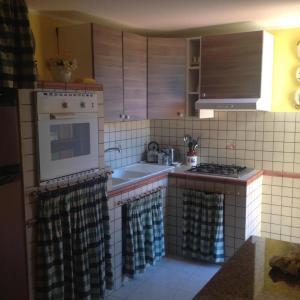 a kitchen with a sink and a stove top oven at Villa La Martina in Fontane Bianche