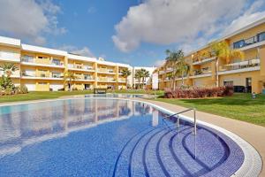 a swimming pool in front of a building at Albufeira Paradise with Pool by Homing in Albufeira