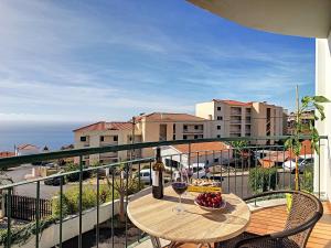 een balkon met een tafel met een glas wijn bij Cliff Refuge by LovelyStay in Santa Cruz