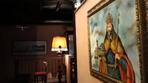 a picture of a painting hanging on a wall at Casetta Di Carlo Magno in Sutri