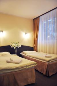 En eller flere senge i et værelse på Hotel Pojezierze