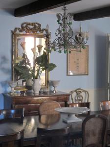 a dining room with a table and chairs and a chandelier at Guest House Arco Dei Tolomei in Rome