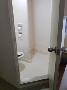 una puerta abierta a un baño con aseo en ibis Budget - Campbelltown en Campbelltown