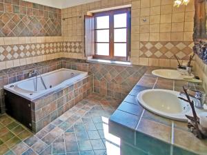 a bathroom with two sinks and a tub at Guesthouse Toxotis in Pirgos Dhirou
