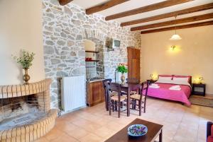 a living room with a bed and a table at Guesthouse Toxotis in Pyrgos Dirou