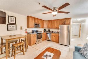 a kitchen with wooden cabinets and a stainless steel refrigerator at Stroll to Slopes, Village Area, Ski in-out MtLodge 345 in Snowshoe