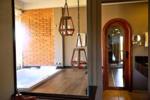 a bath tub in a room with a mirror at Tenondé Park Hotel in São Miguel das Missões