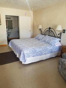 a bedroom with a large bed and a couch at Butch Cassidy's Hideout in Circleville