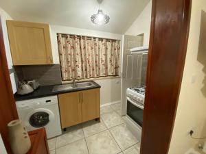 a small kitchen with a sink and a dishwasher at Guest House B&B in Oxford