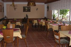 a dining room with tables and chairs in a restaurant at Pension Hermes in Wallenborn