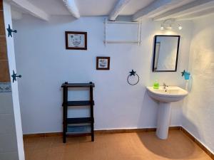 a bathroom with a sink and a mirror at La Casita Blanca- La Almona Chica in El Chorro +40 photos