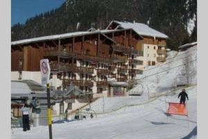 a large building on a ski slope in the snow at Les studios du chalet club Valfréjus in Modane