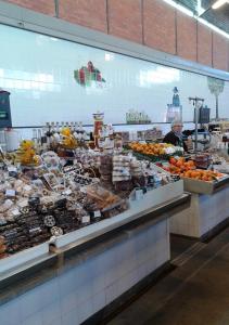 a display case in a grocery store filled with lots of food at Edificio Lavadeiras in Olhão