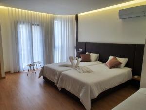 a hotel room with a bed with towels on it at Residencial Dom Manuel in Fafe