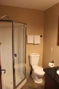 a bathroom with a toilet and a glass shower at Woodhaven # 8 in Sun Peaks in Sun Peaks +21 photos