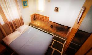 
a bed in a room with a wooden floor at Apollonia Hotel Apartments in Varkiza
