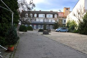 a cobblestone street in front of a building at Apartmány Mojžitov dvor in Lučenec