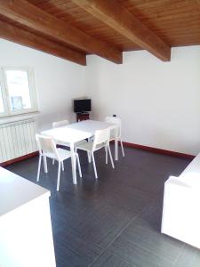 a dining room with a white table and white chairs at PESCARA HOME anto in Pescara +90 photos