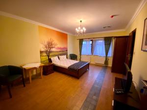 a bedroom with a bed and a table and chairs at AmberRoom in Pruszcz Gdański