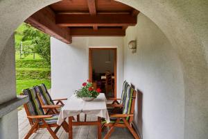 una mesa con sillas y un jarrón de flores en el patio en Haus Elfi Fiegl, en Oetz