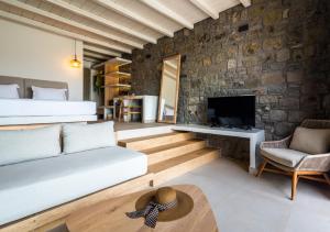 a living room filled with furniture and a fireplace at Hotel Milos Sea Resort in Adamantas