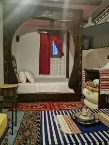 a living room with a bed and a window at Dar naya in Chefchaouene